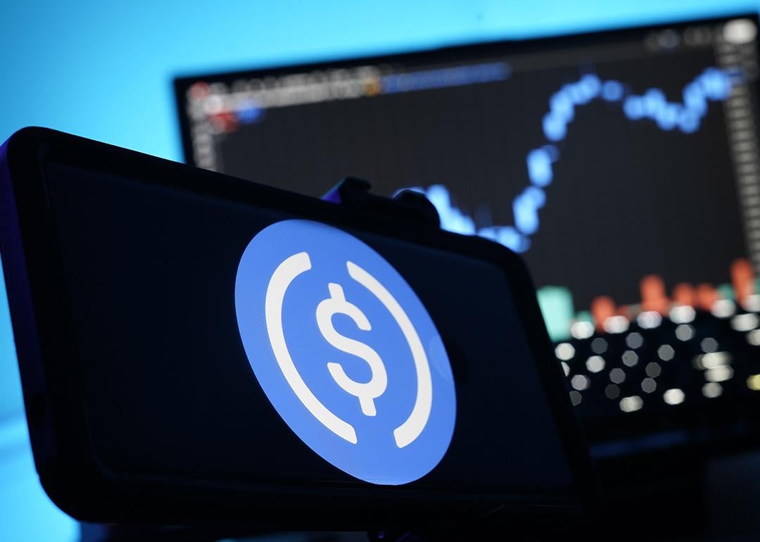 A stablecoin logo displayed on a smartphone.