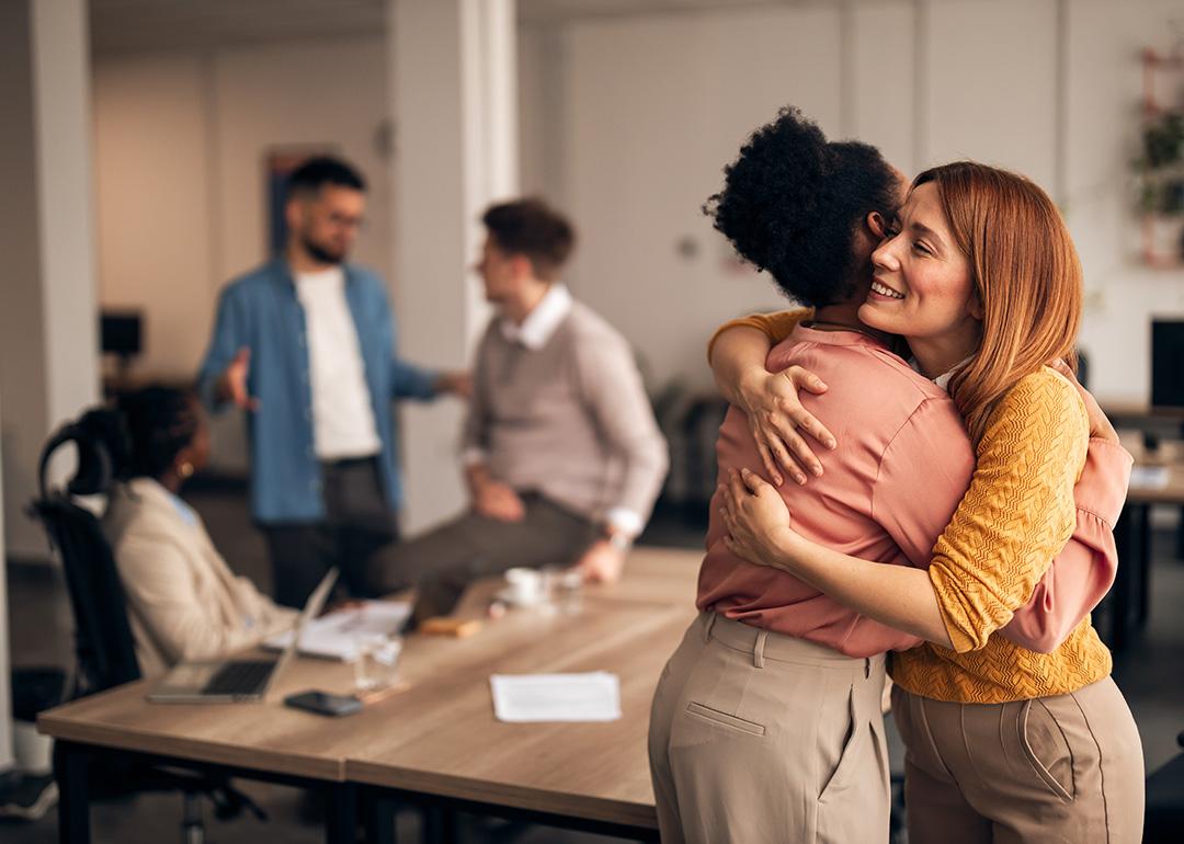 An office worker embracing a colleague. 