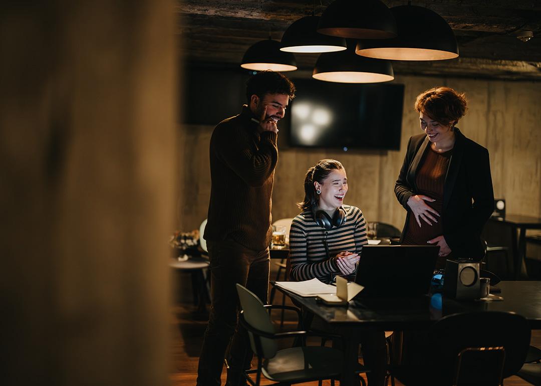 Coworkers having a fun conversation in their office.