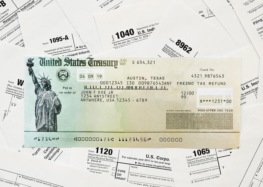 A US Treasury refund check on top of tax forms.