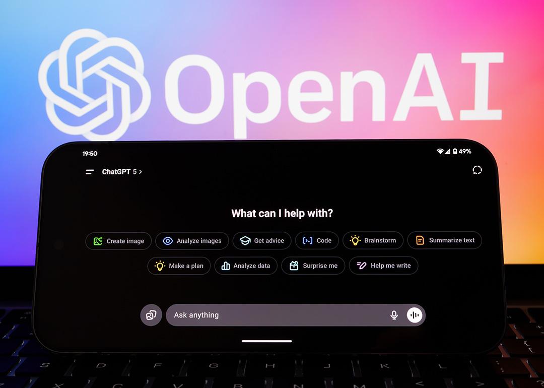 ChatGPT 5 interface on a phone with the logo of OpenAI in the background.
