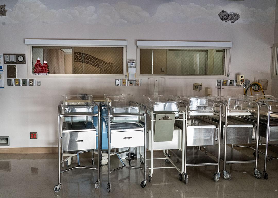 Empty infant beds in a corner of a maternity ward.