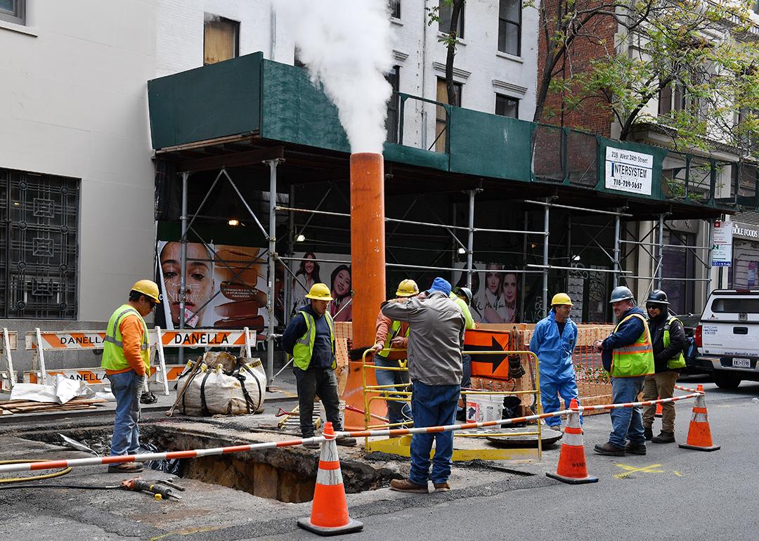 A team of workers on a roadside construction site in New York.