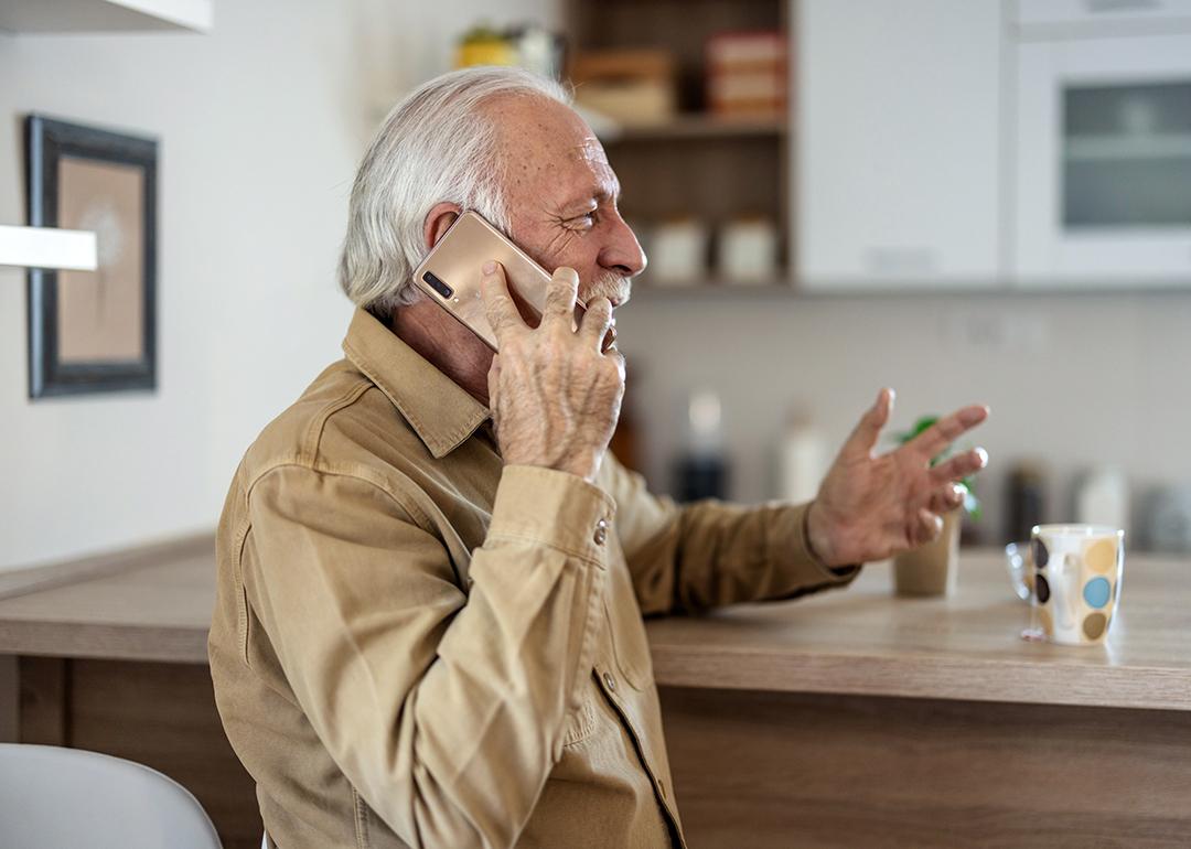 A happy senior man talking on the phone.