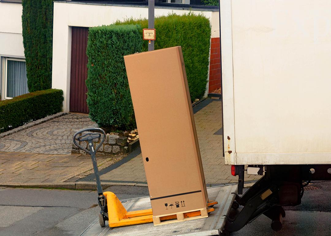 A large parcel box being loaded in a shipping truck.