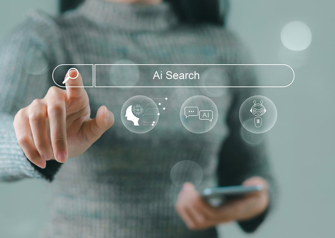 A businesswoman using a smartphone navigating a holographic AI search engine bar.