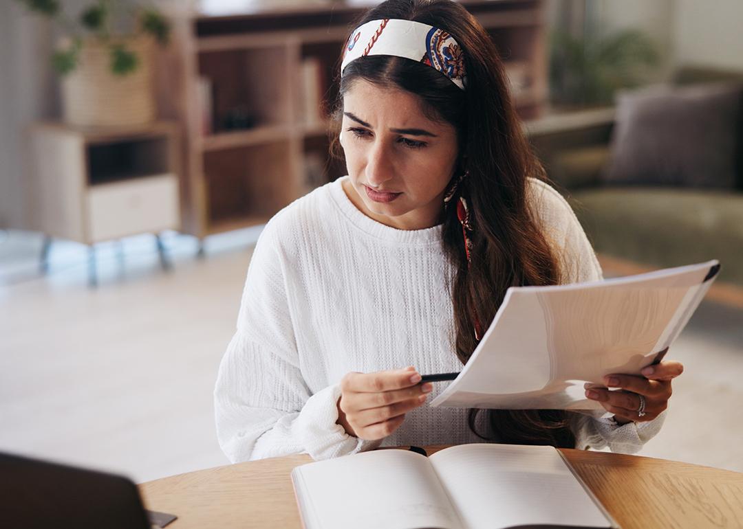 A person going through paperwork at home. 