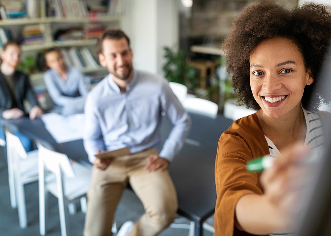 Employees collaborating during a meeting in the office.