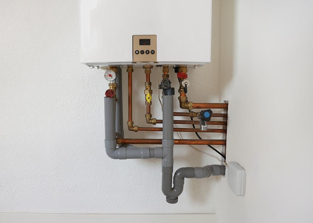 A modern gas boiler on a white wall.