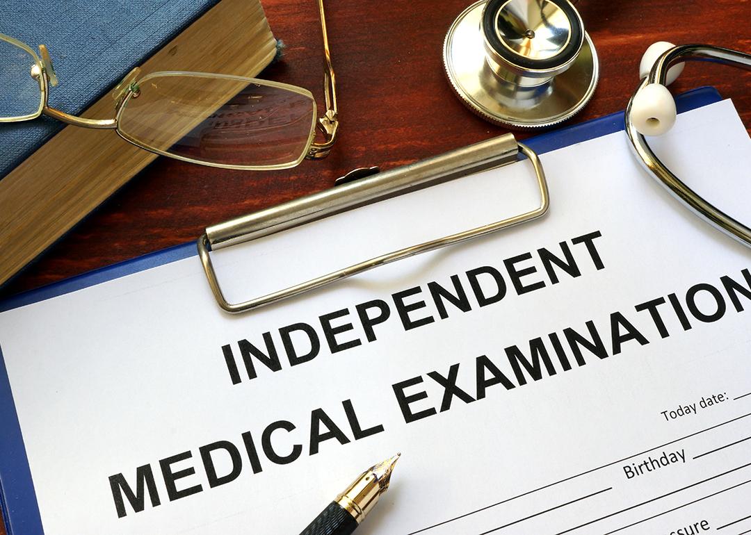An independent medical examination form on a clipboard.