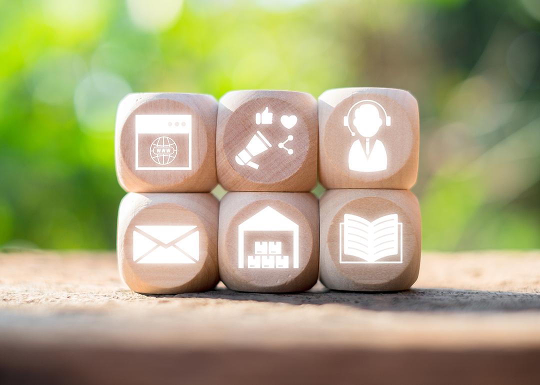 Wooden blocks with icons representing omni channel marketing and communication concepts.