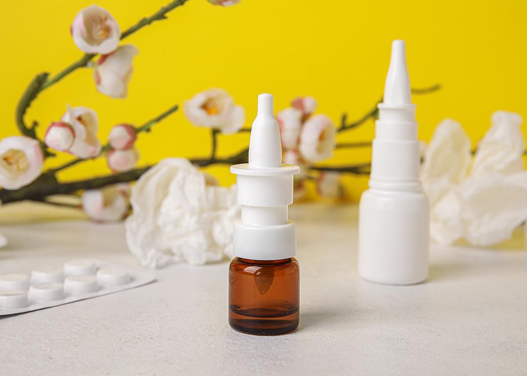 Nasal drops with medicine pills in the background.