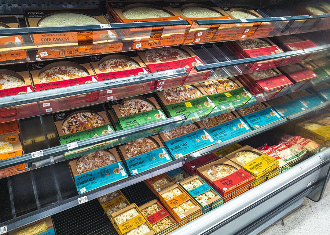 Frozen pizza section at a grocery store.