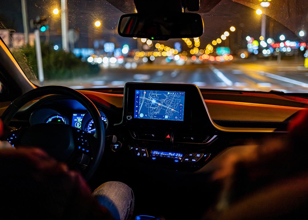 An interior view of a person driving a modern car.