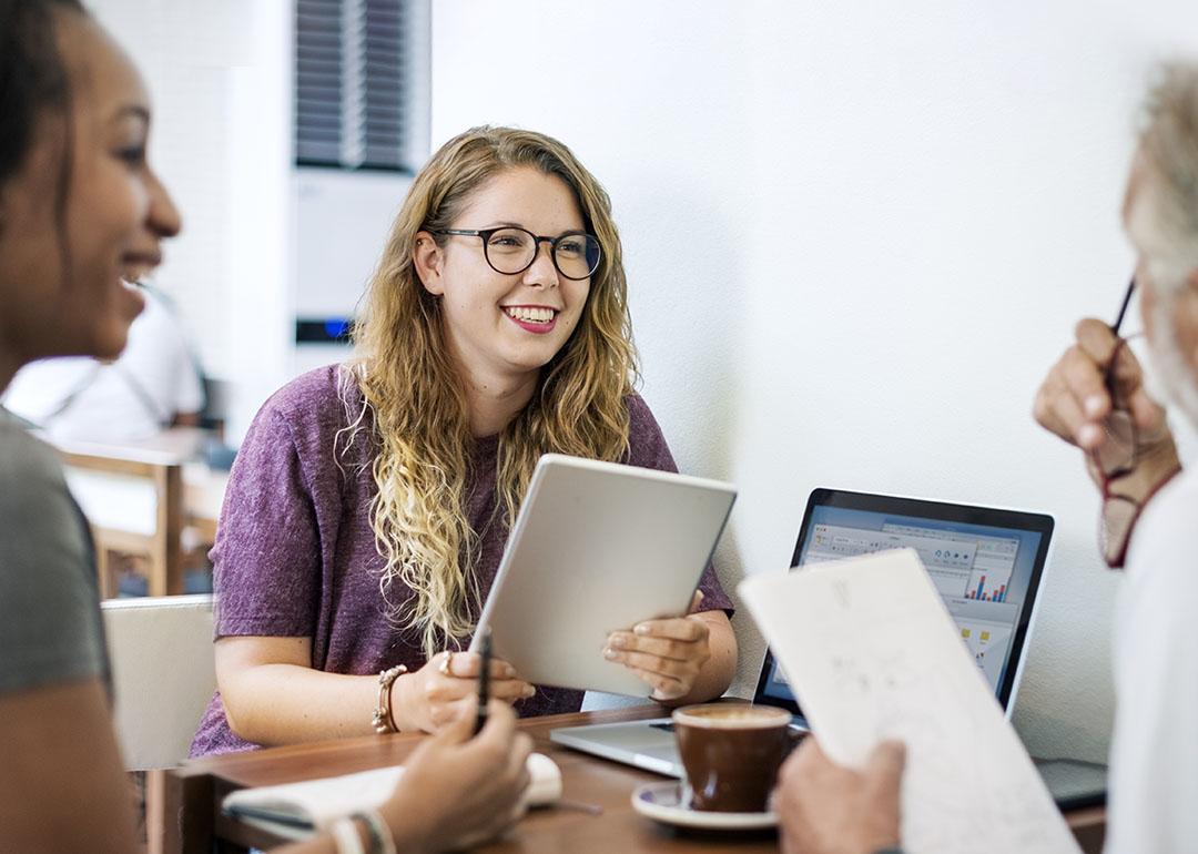 Young colleagues engaged in a discussion with a senior professional.