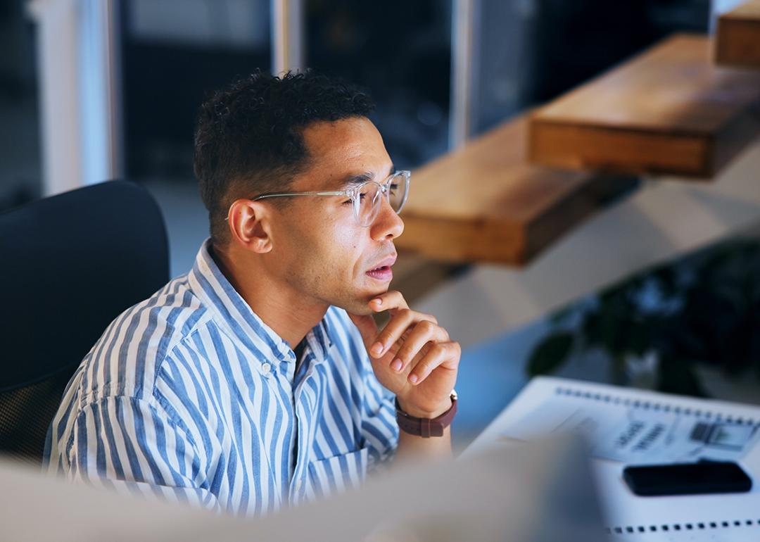 A focused businessman working at night in an office.