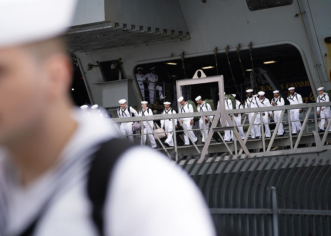 Sailors disembark from the USS Carl Vinson after returning from deployment to their homeport at Naval Air Station North Island in Coronado, California.