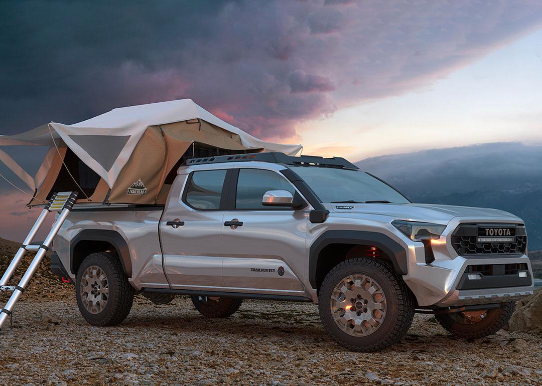 Silver 2023 Toyota Tacoma Truck with a tent built out for camping covering the truck bed. 