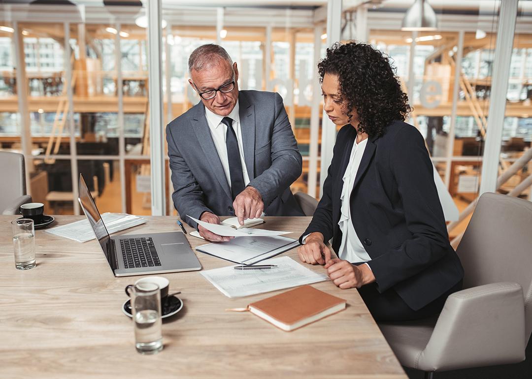 Two business executives reviewing a report.