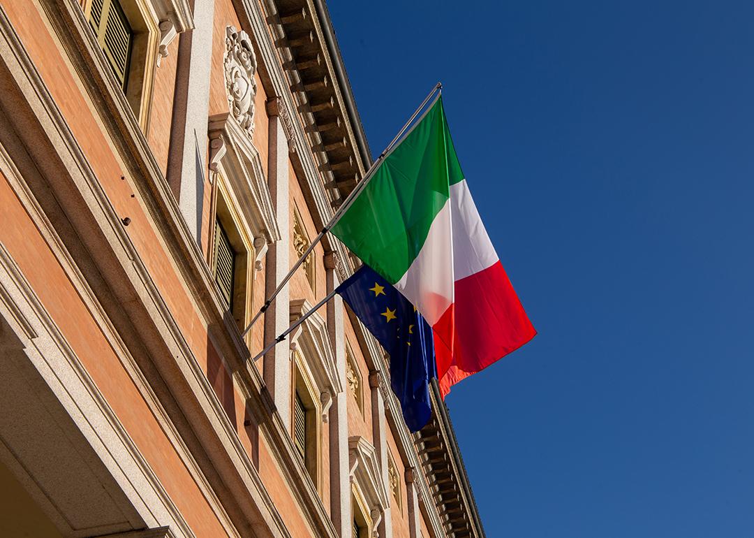 Italy and European Union flags on a balcony of a building in Reggio Emilia City, Italy. 