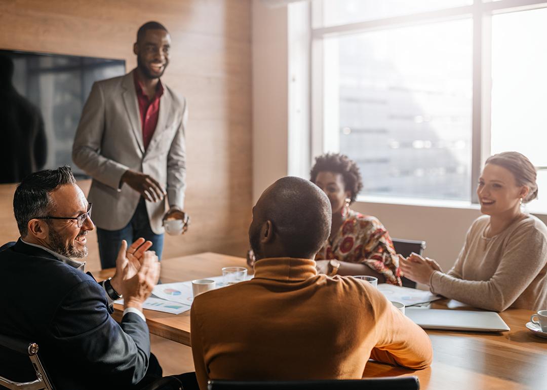 Coworkers enjoying a lighthearted moment during an office meeting.