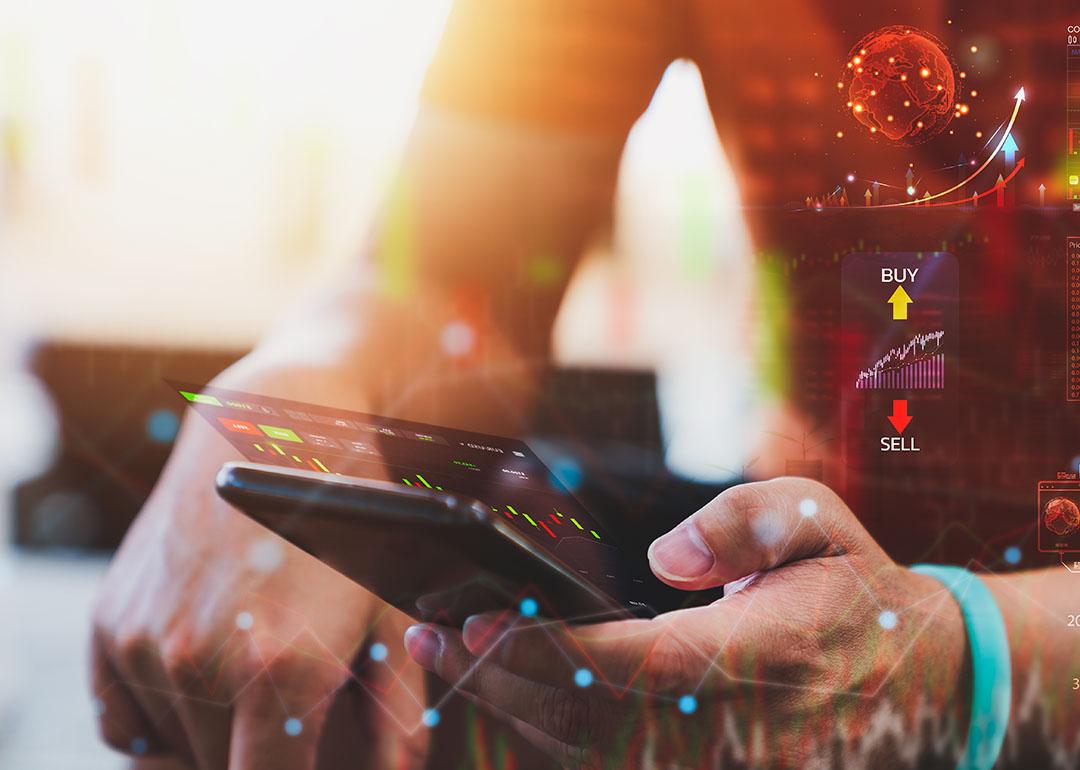 Person analyzing cryptocurrency data on a phone.