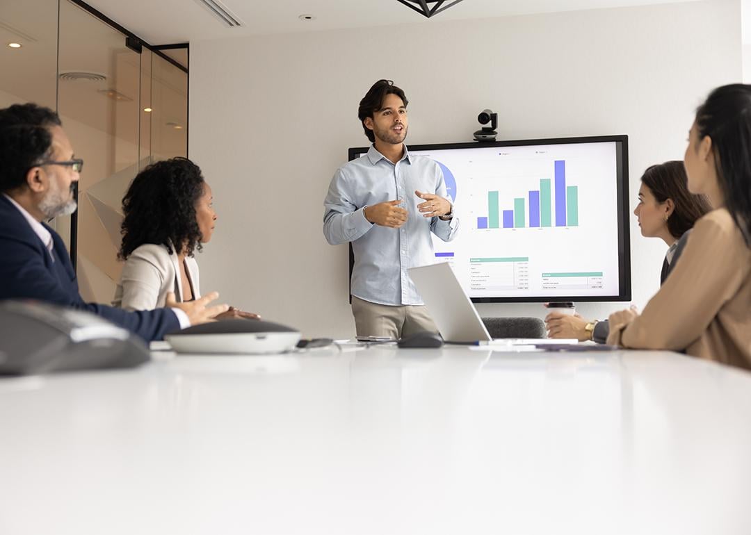A speaker giving a presentation to a business team.