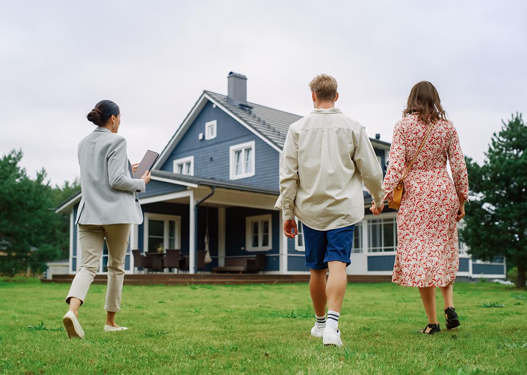 A young couple viewing a property for sale with an agent.