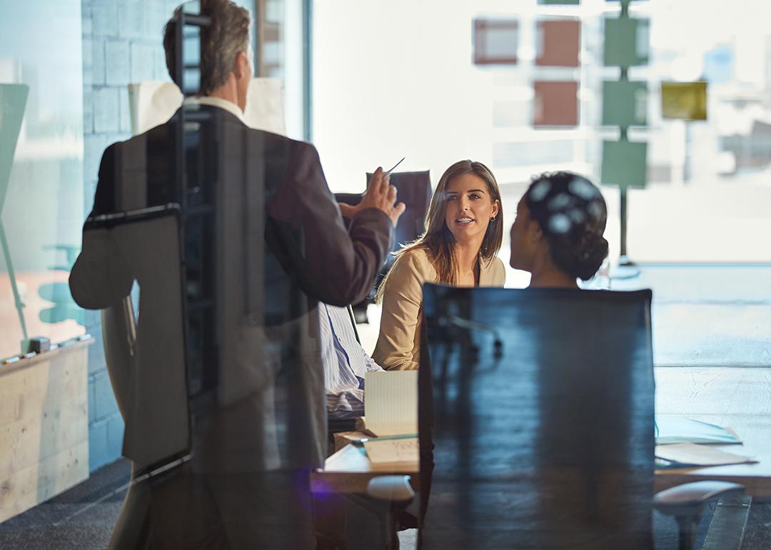 A manager discussing during an office meeting. 