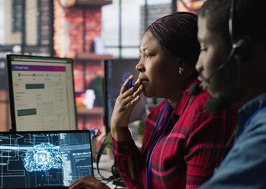 Customer service agents brainstorming together with AI chatbot. 