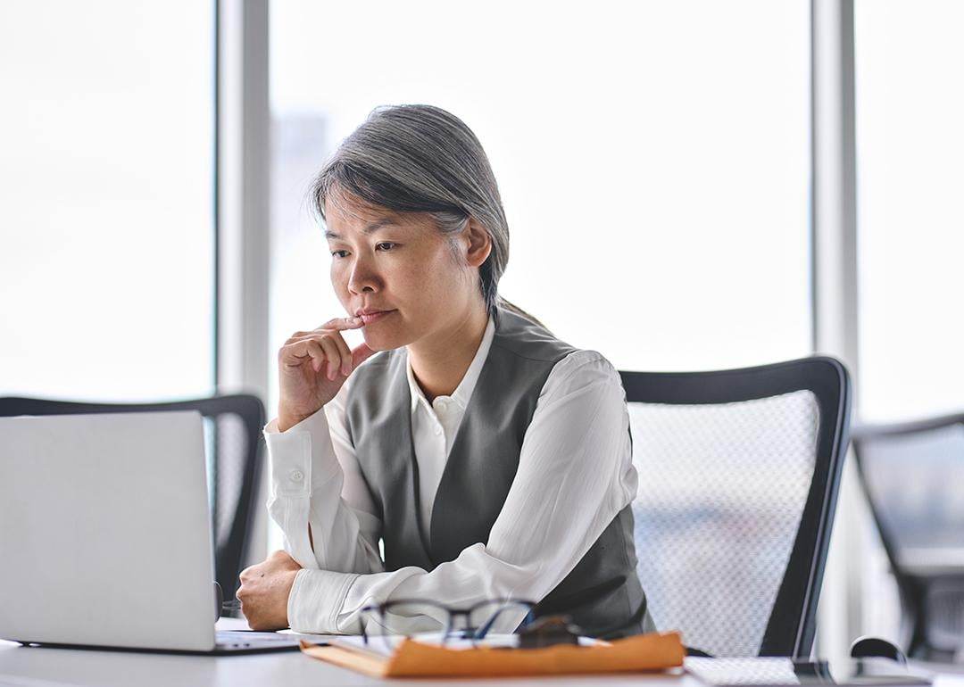 A business manager reviewing work tasks in an office. 