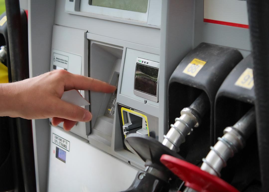Person entering numbers on a fuel pump station keypad.