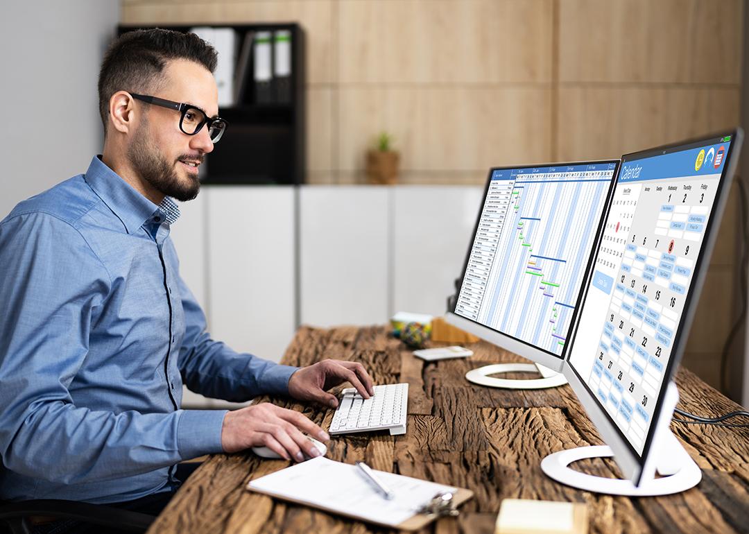 An employee working on calendar scheduling and staff time sheet.