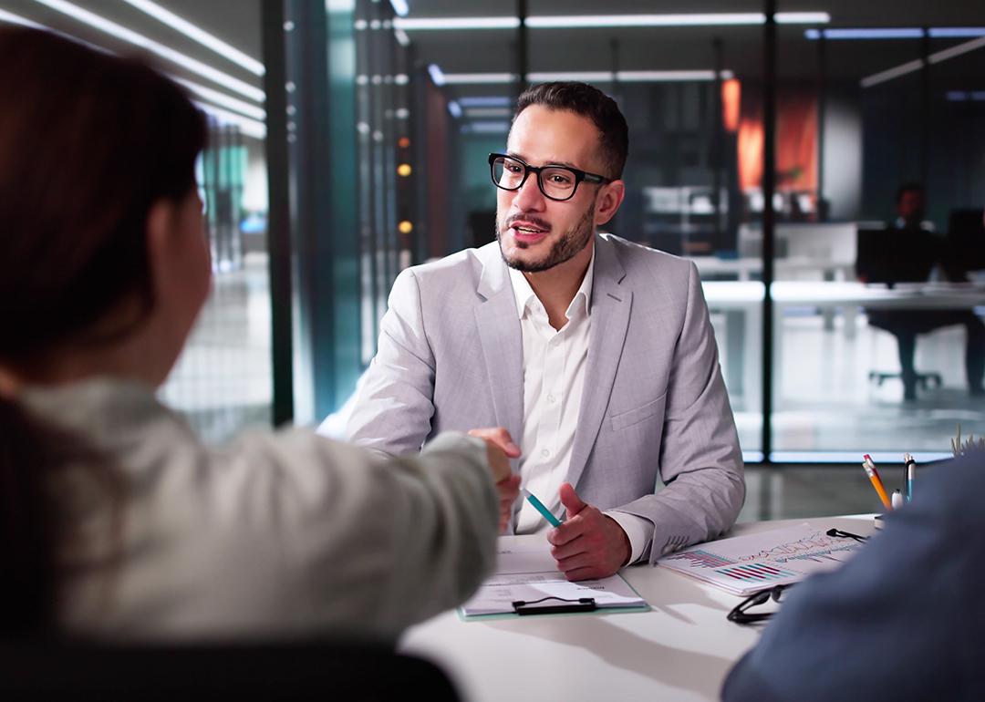 A tax advisor shaking hands with a client.