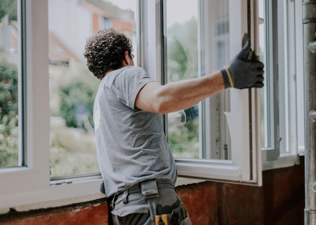 A window installer assembling a new unit of windows for a home.