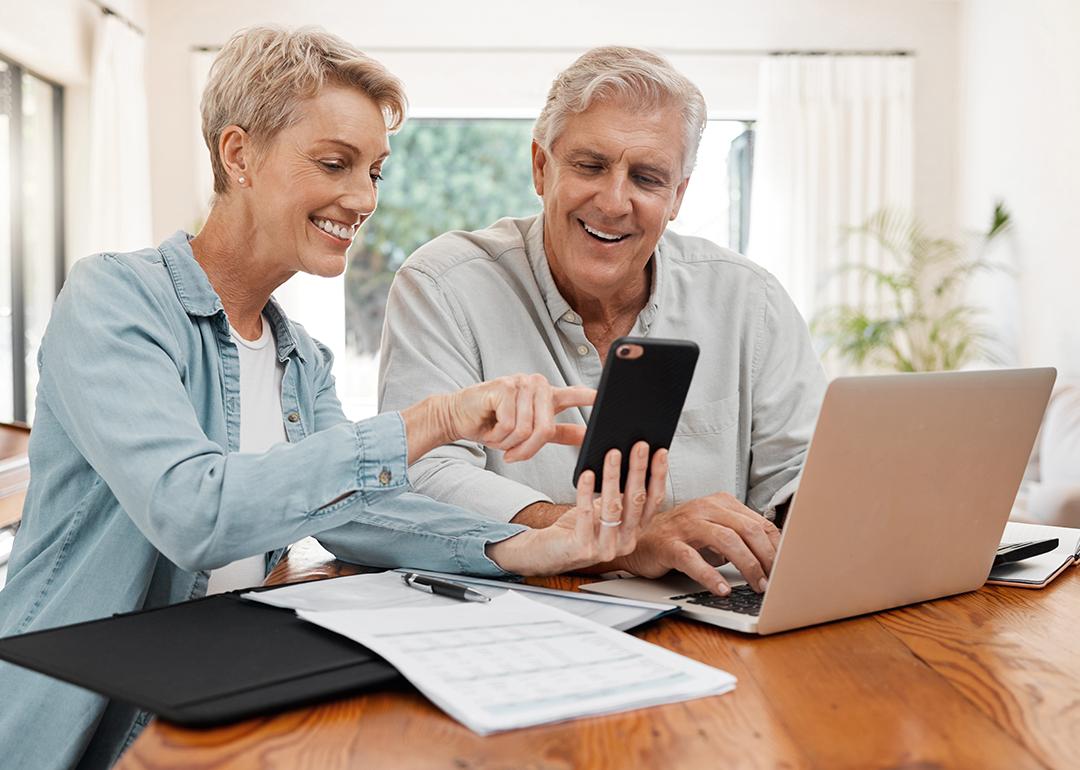 An elderly couple working on their retirement documents at home.