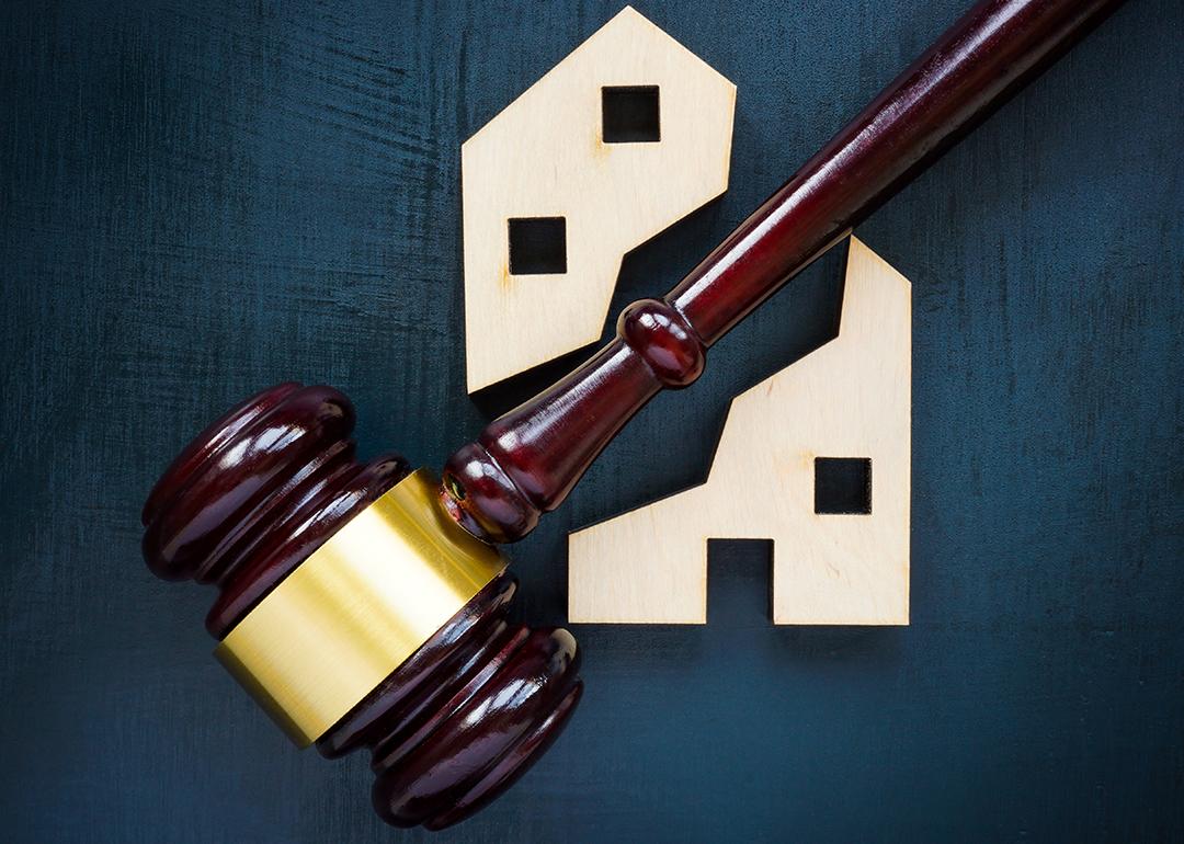 A wood house block separated by a gavel into two parts.