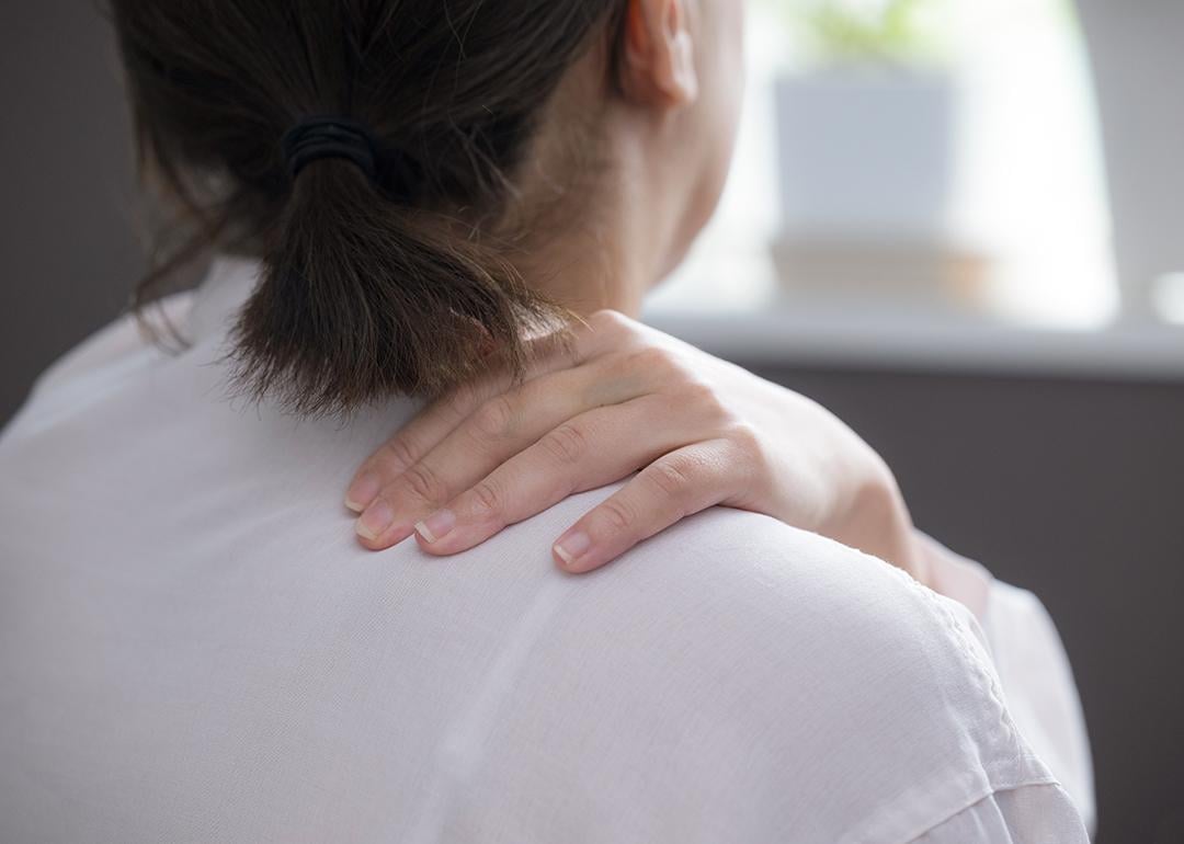 Woman suffering from stiff shoulders.