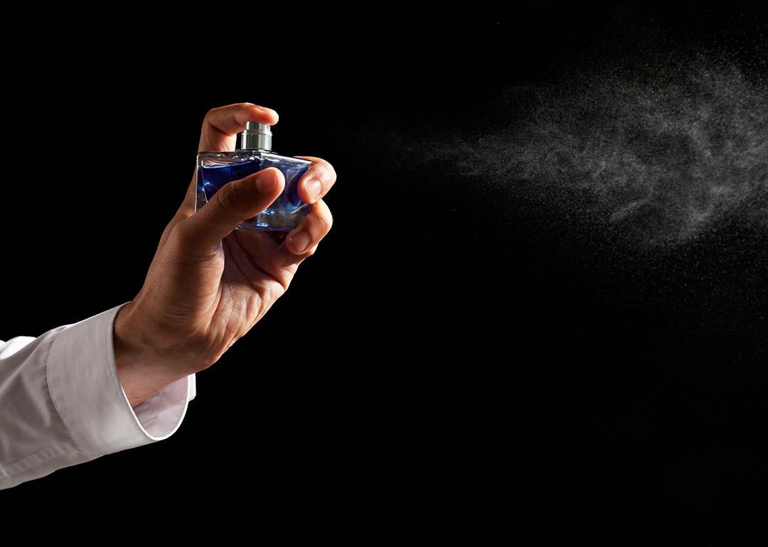 Luxury perfume being sprayed in the air.