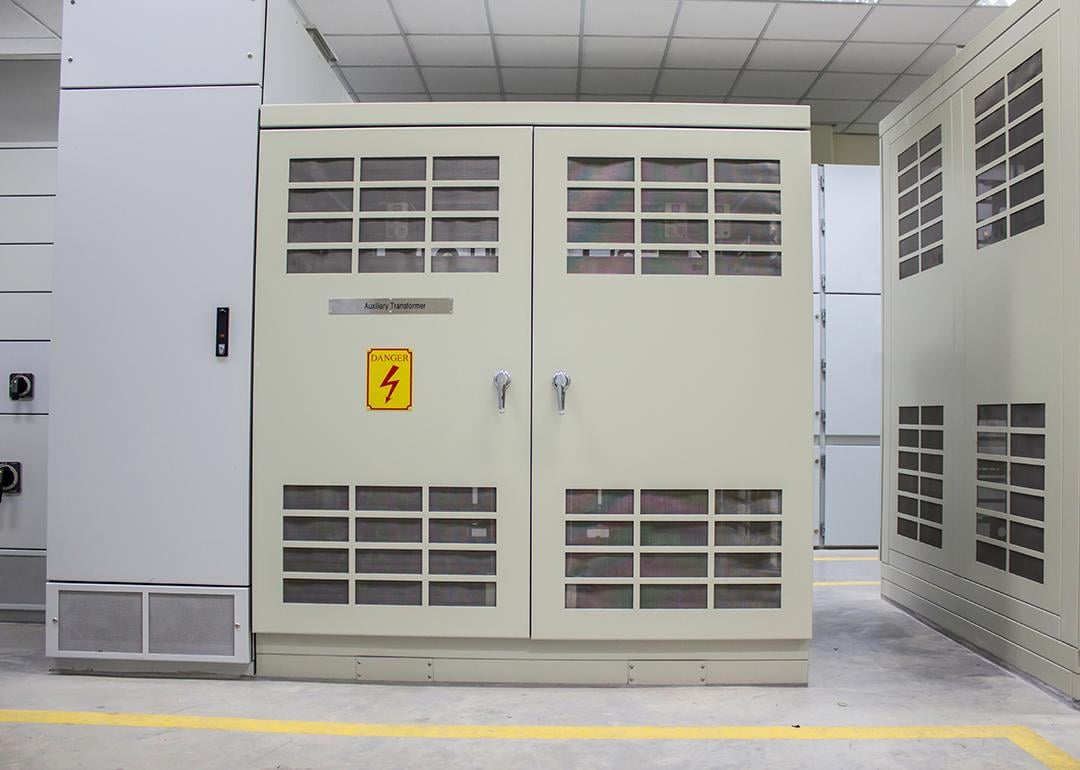 A dry type transformer installed in an electrical room from a power plant.