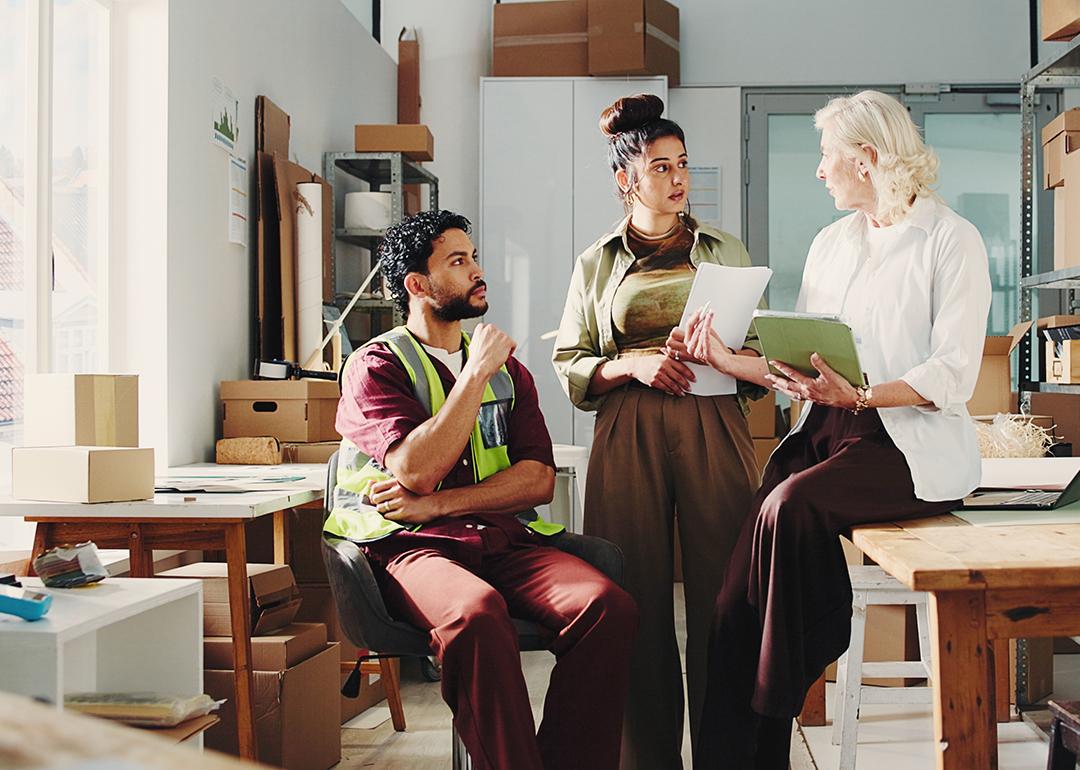 A team checking in together for delivery and retail updates in a stock room.