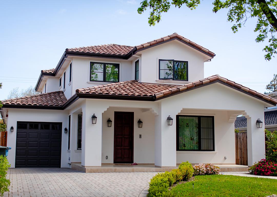 An American suburban residential house and a garage with landscaping.
