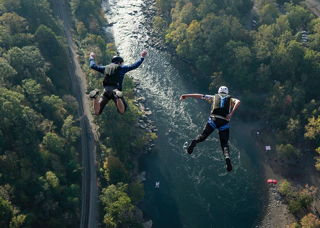 Two jumpers leap from New River Gorge Bridge in West Virginia.
