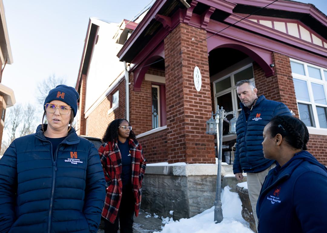 Members of Ohio's Hamilton County Quick Response Team, which helps people who use fentanyl get treatment, stand outside a brick home with snow on the ground.  Ohio had the largest drop in opioid overdose deaths of any state as of October 2025.