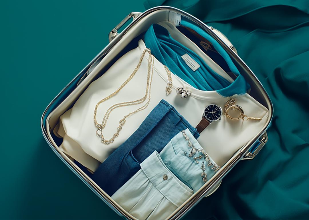 A travel bag with clothes and jewelry.