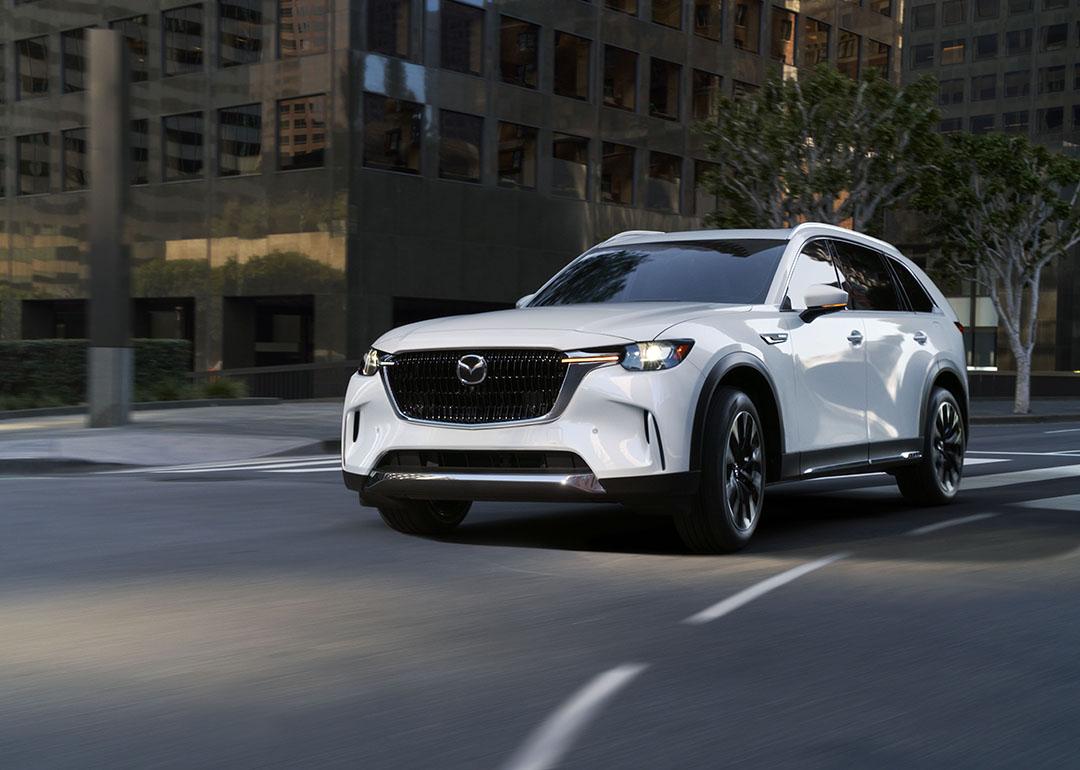 A white Mazda CX-90 on the road.