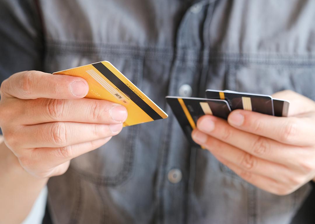 Man choosing from several credit cards.