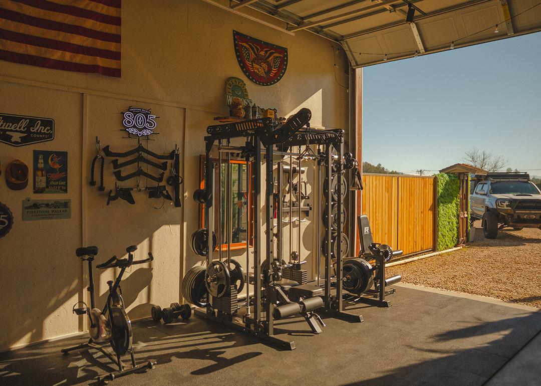 Gym equipment set up in a home's garage.