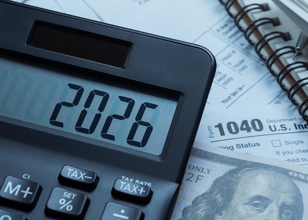 '2026' on a calculator over tax forms.