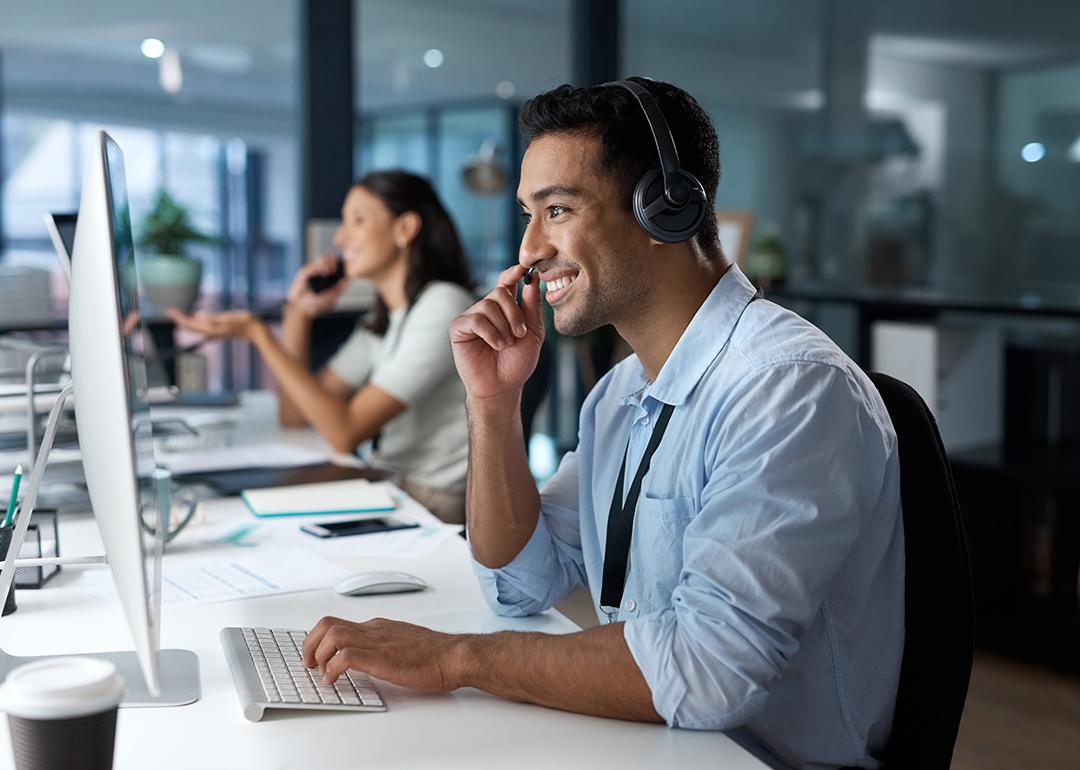 A happy male customer service representative in a call.